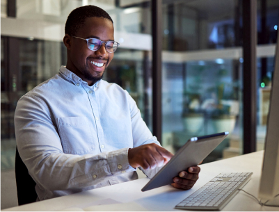 Male African American IT professional working on tablet and smiling