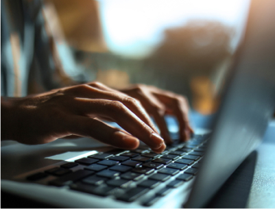Fingers typing on laptop keyboard